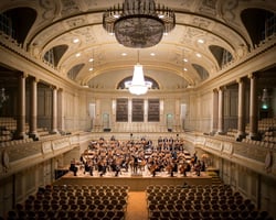 music group performing in empty concert hall