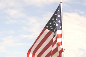 American flag in front of white sky