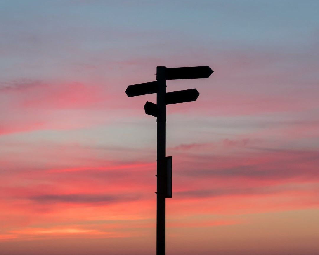 Signpost backlit by sunset