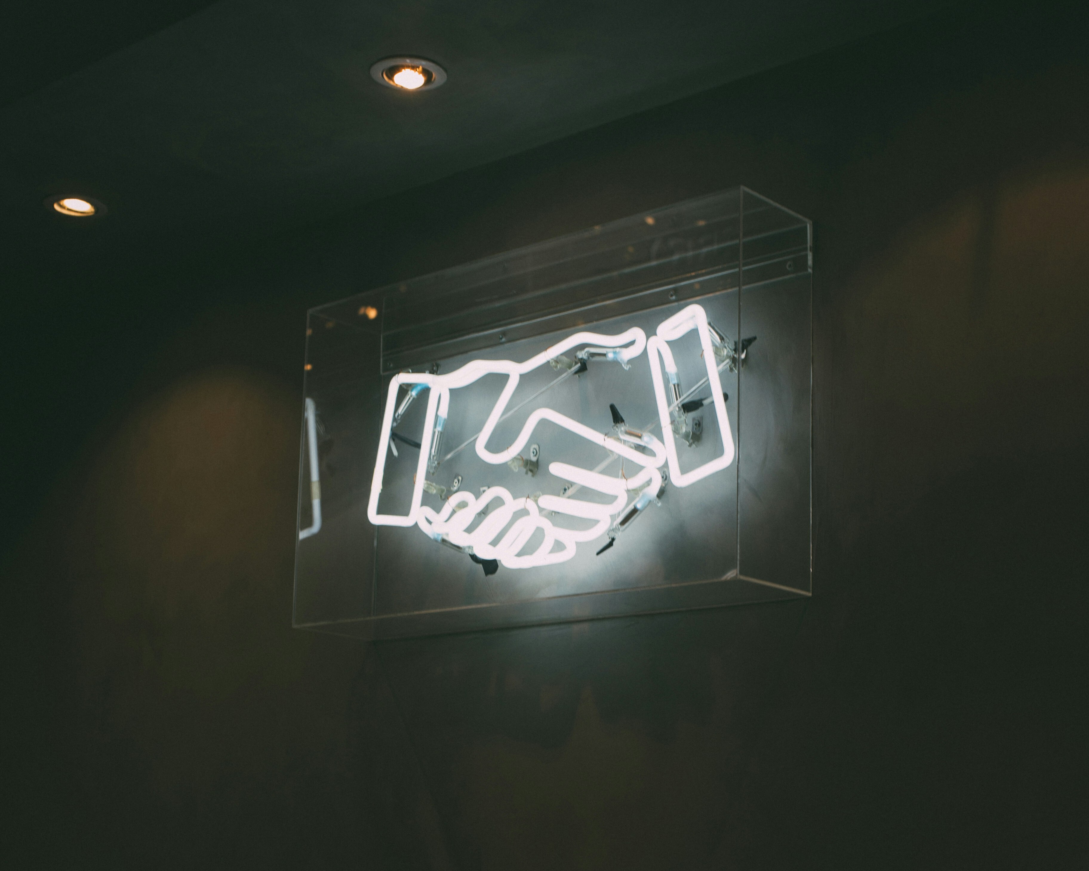 neon sign of a handshake